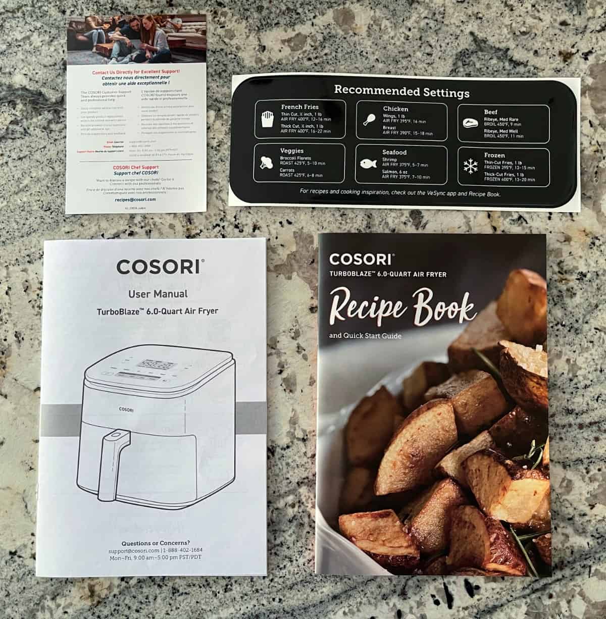 Cosori air fryer user manual, recipe booklet, recommended settings and cook times, and customer support contact card.