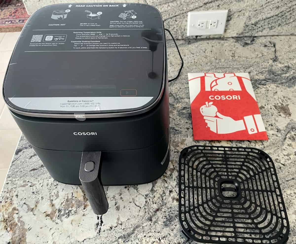 Unboxing brand new Cosori TurboBlaze 6.0-Quart Air Fryer on kitchen counter..