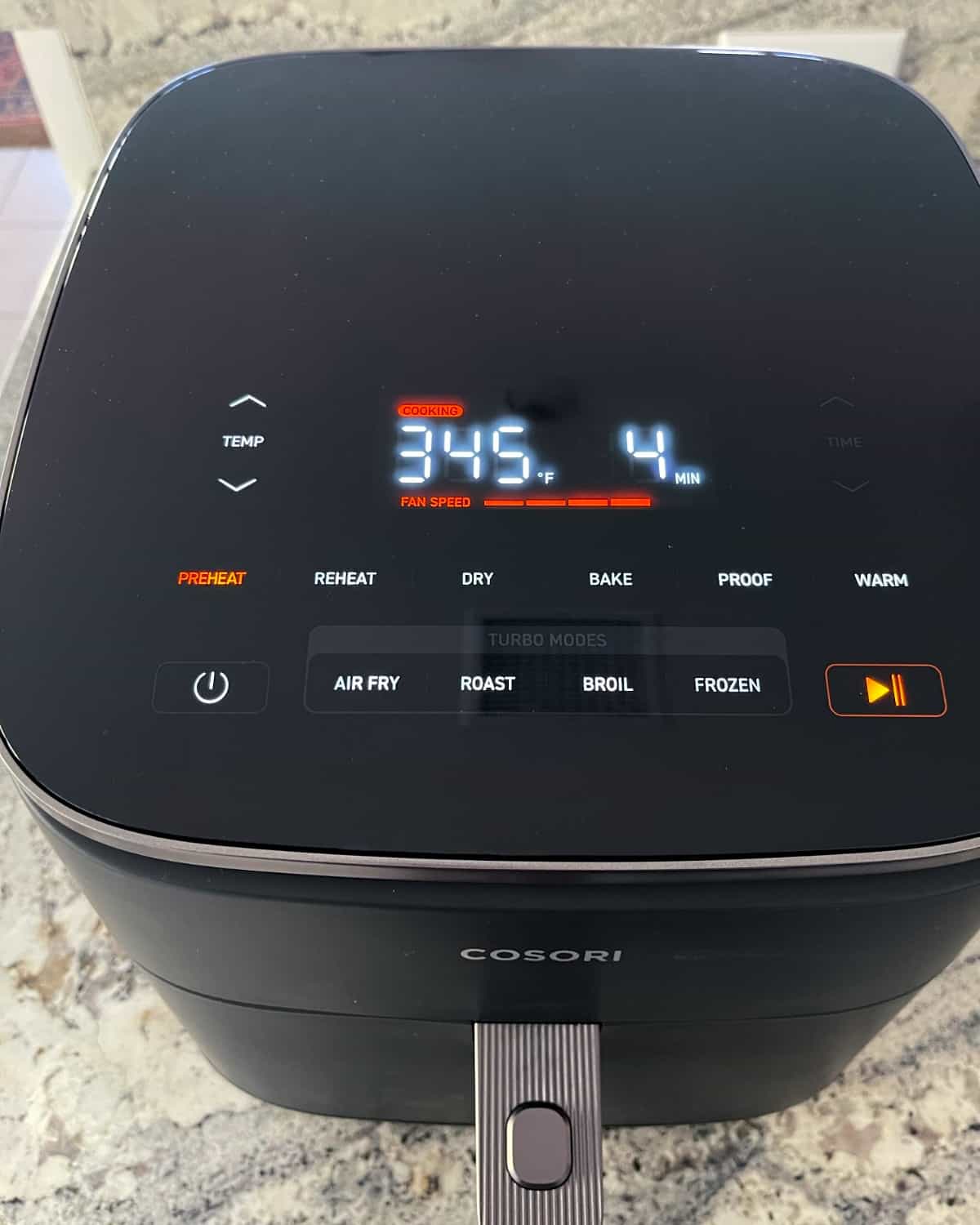 Preheating Cosori TurboBlase Air Fryer at 345F degrees for 4 minutes.
