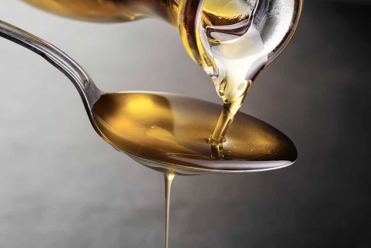 Olive oil being poured into a spoon