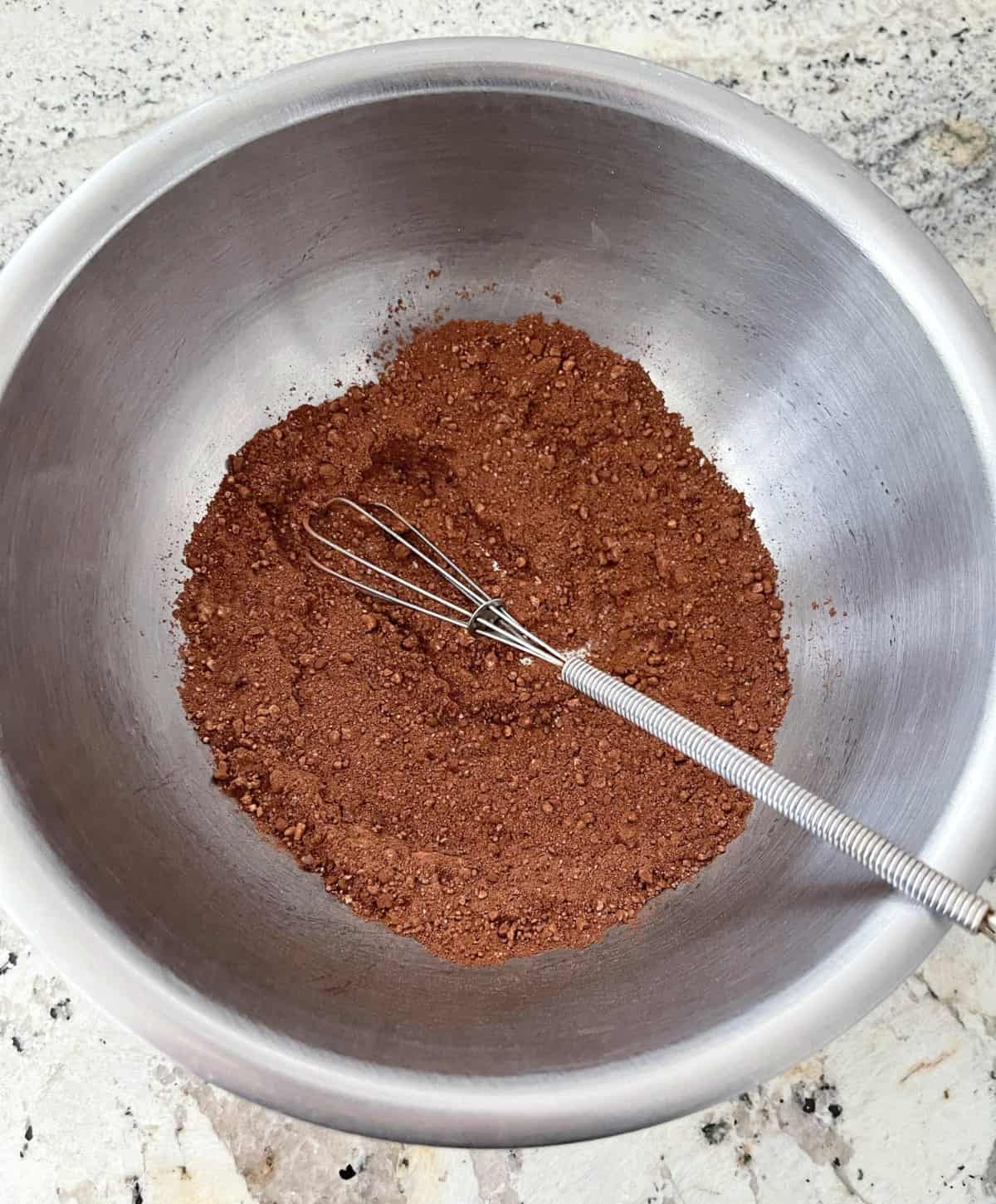 Whisking dark cocoa powder, peanut butter powder, baking powder and Truvia zero calorie sweetener in small bowl.