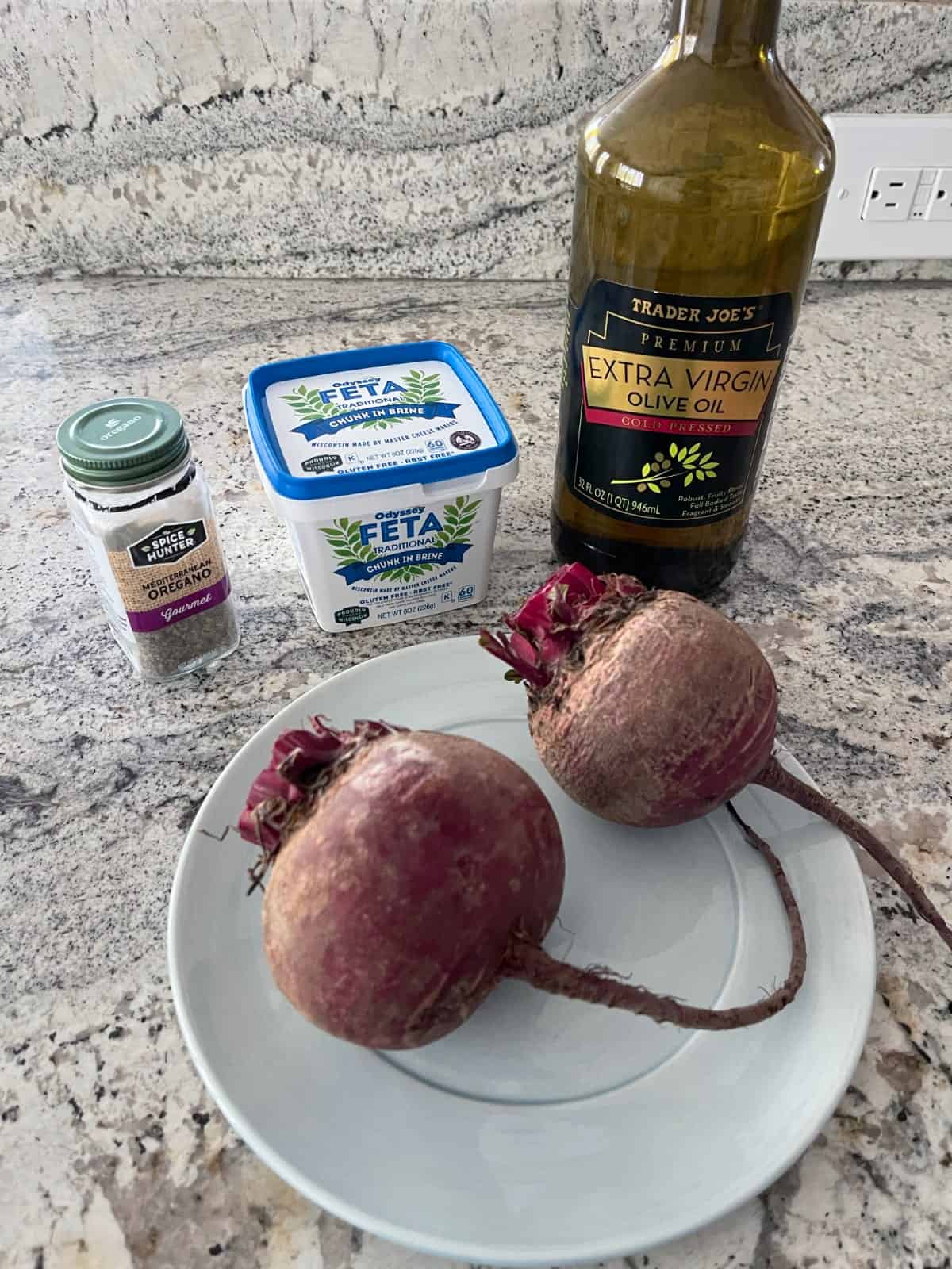 Ingredients including two red beets, extra virgin olive oil, feta cheese and dried oregano.