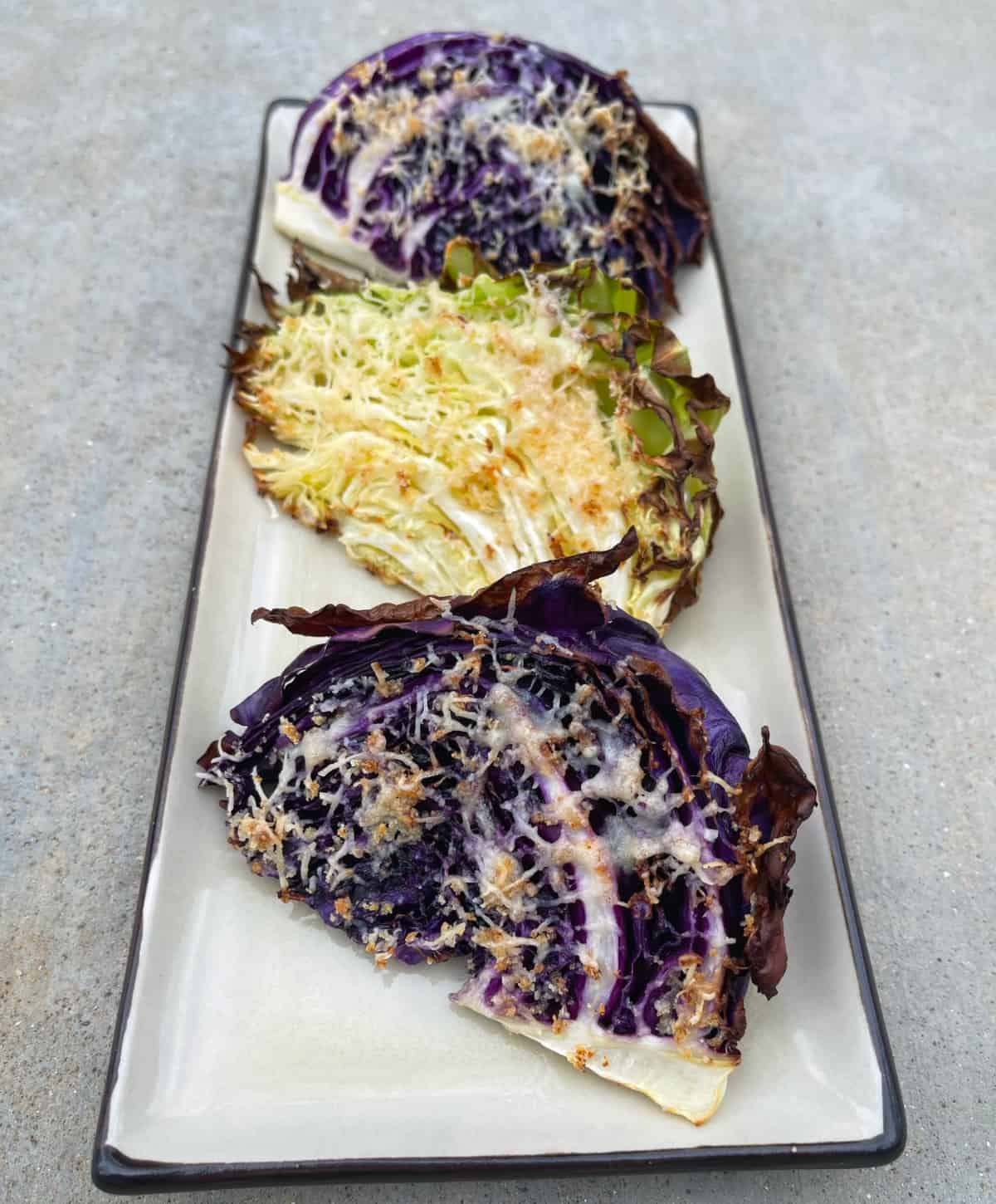 Three wedges air fryer roasted Parmesan cabbage on serving platter.