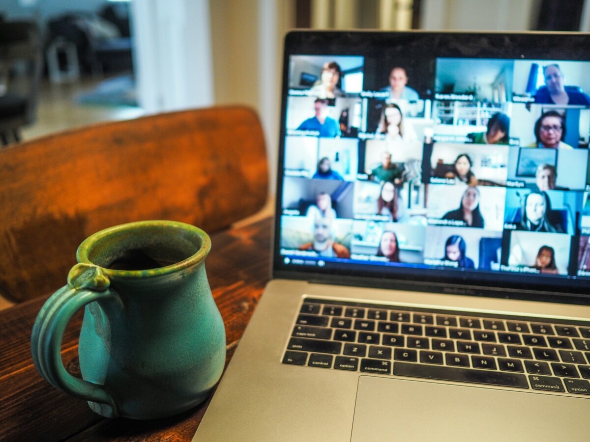 Coffee mug next to open laptop screen.