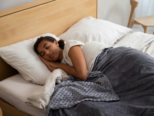 Young woman sleeping in bed peacefully