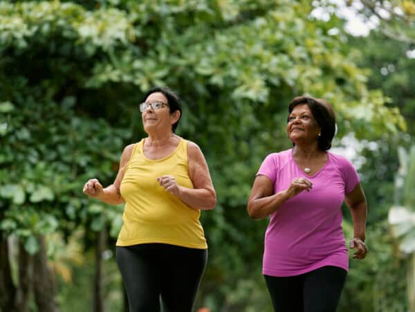 Two women jogging together - workout buddies