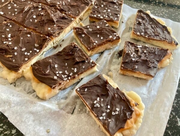 Frozen Peanut Butter Banana Chocolate Bark on a Parchment Lined Cookie Sheet Ready to Enjoy