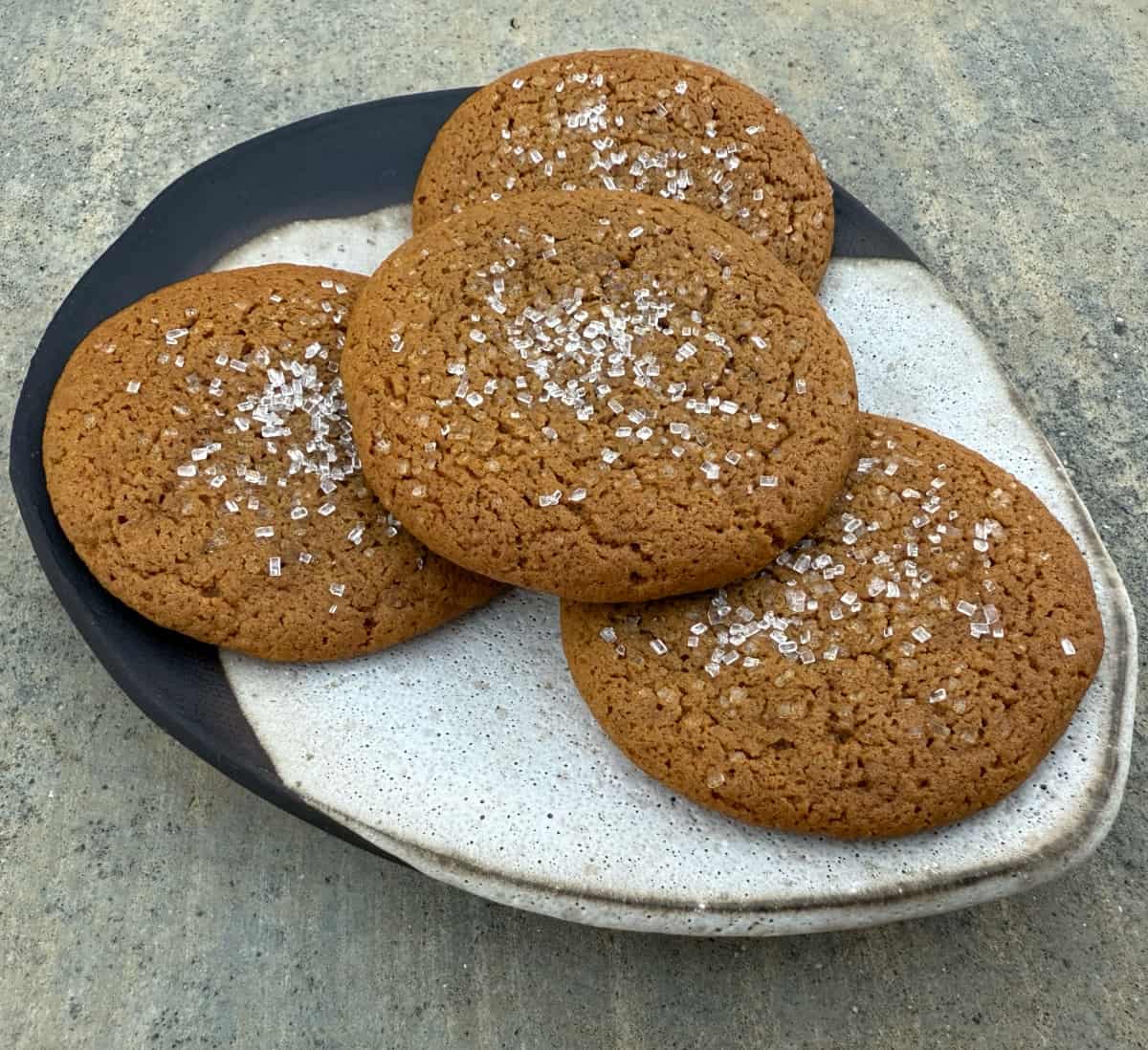 Sugar Crusted Ginger Cookies stacked on small plate.