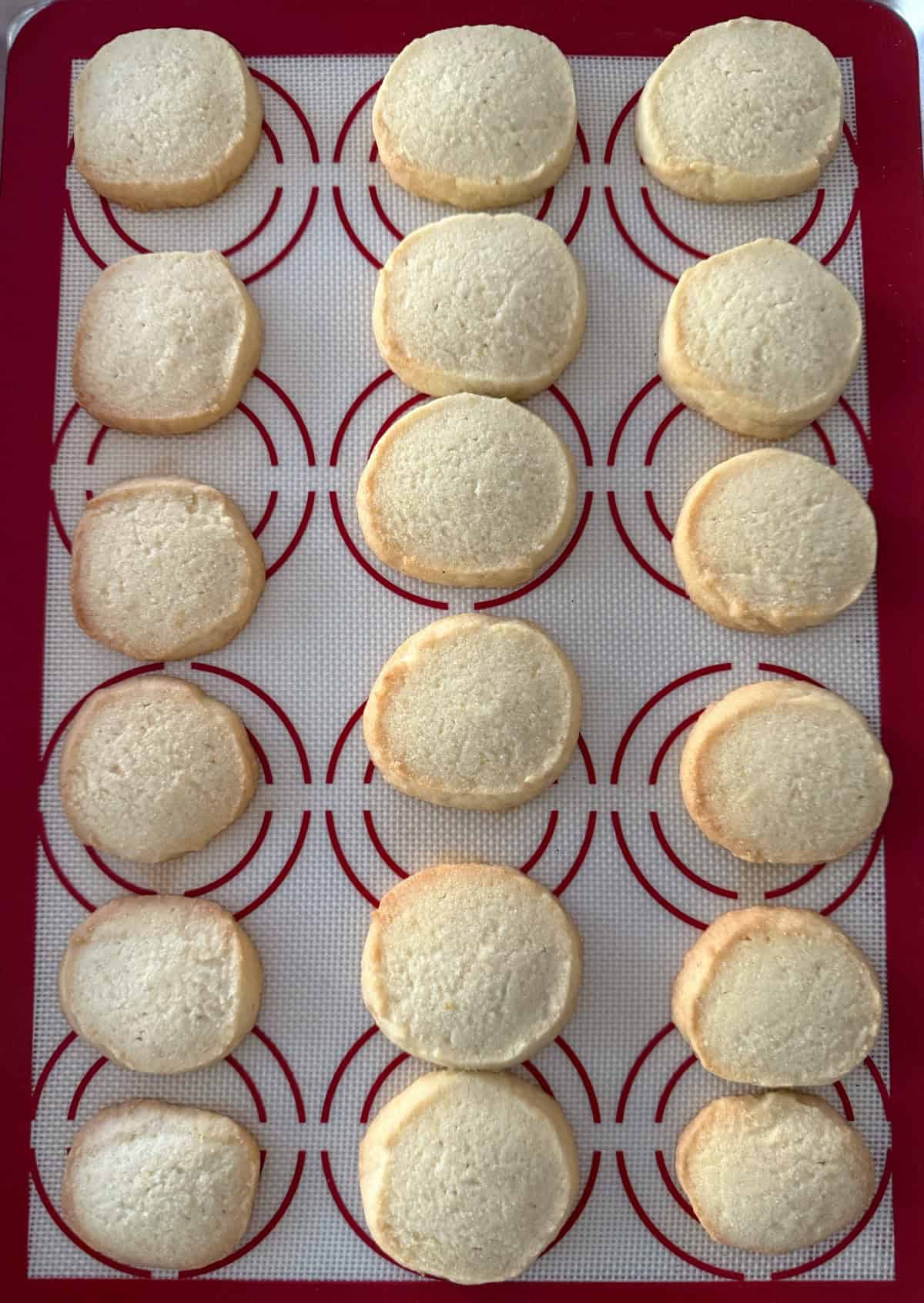 Fresh baked lemon shortbread cookies on baking sheet.