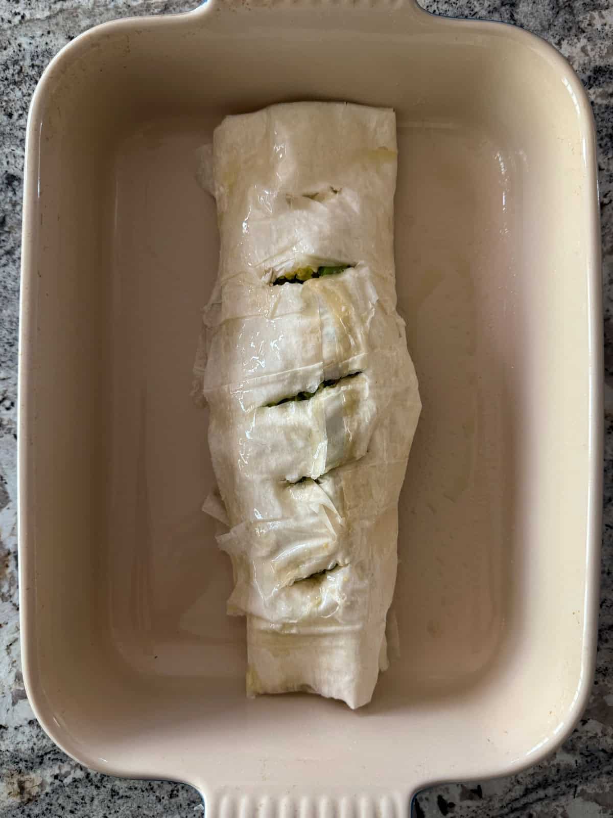Unbaked Egg and Broccoli Strudel in baking dish.