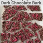 Sheet pan of broken pieces of raspberry quinoa dark chocolate bark artfully arranged with text overlay for Pinterest PIN