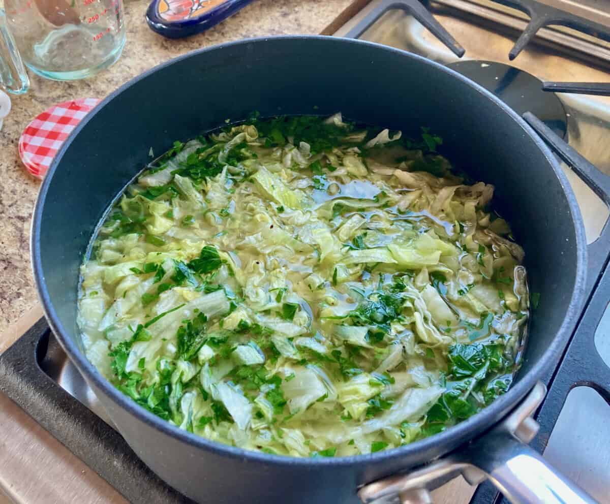 Soup pot filled with Italian Style Lettuce Soup.