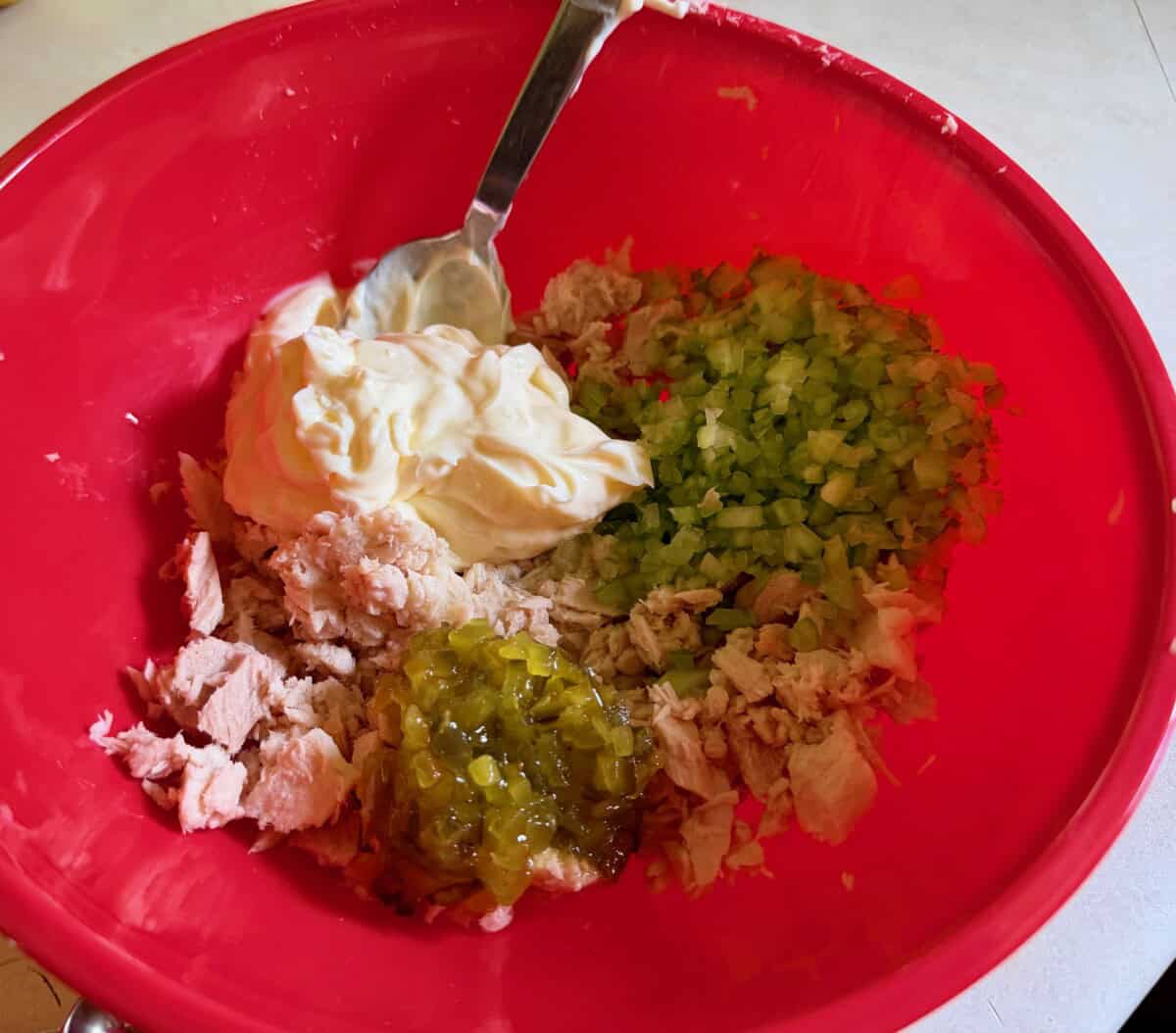 Tuna, mayo, diced celery, lemon juice, pickle relish in red mixing bowl