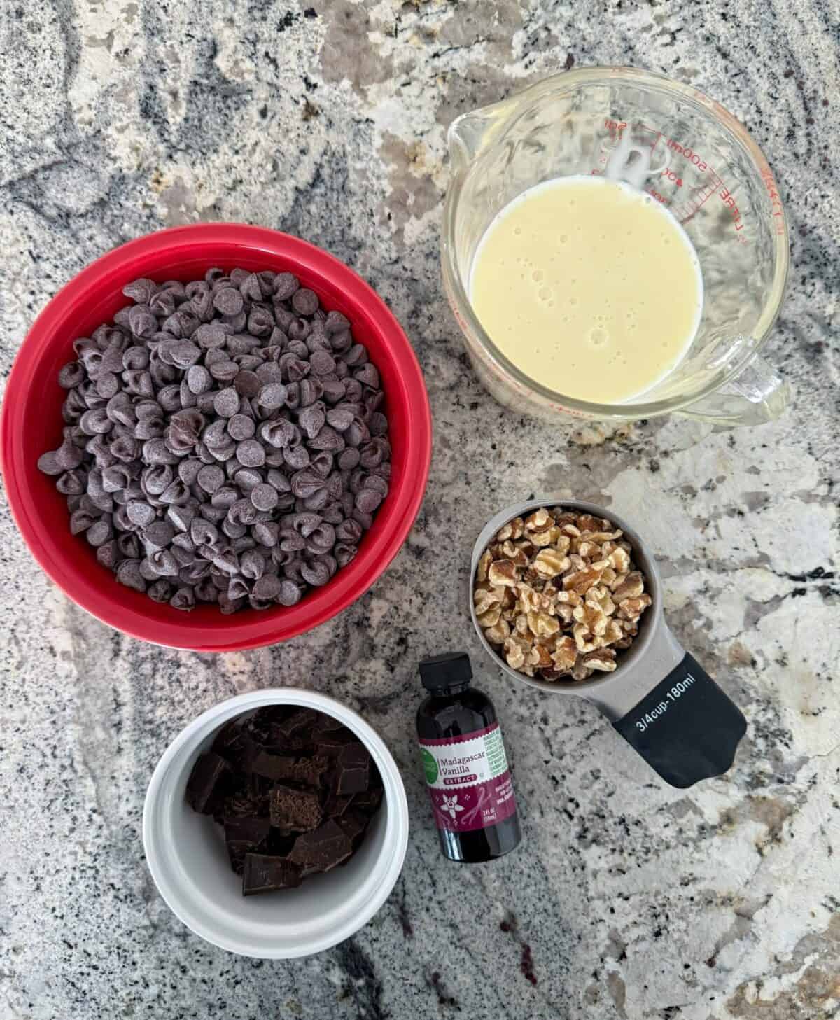 Chocolate chips, chopped chocolate, chopped walnuts, vanilla extract and sweetened condensed milk.
