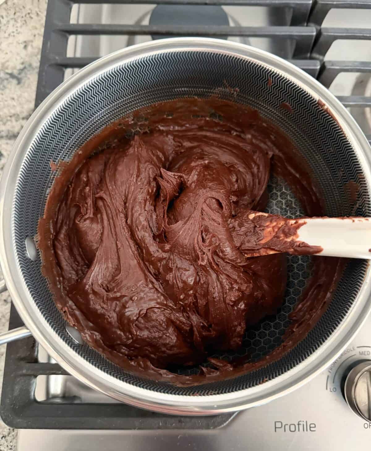 Melting chocolate and sweetened condensed milk in sauce pan.